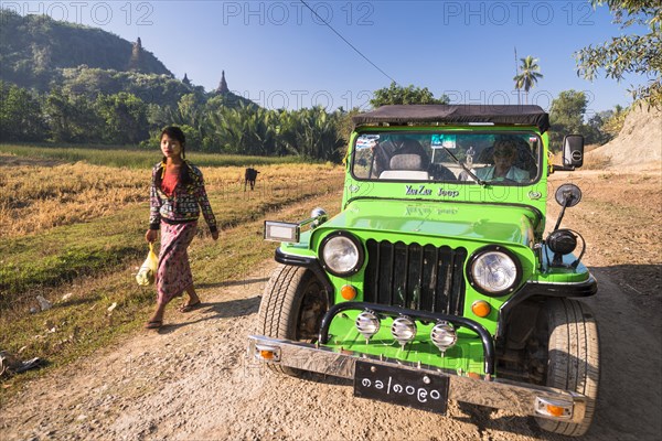 Woman walking next to a four-wheel drive vehicle