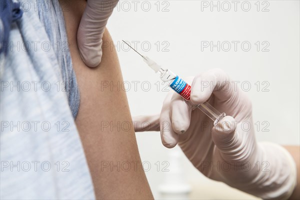 Young woman getting a flu shot