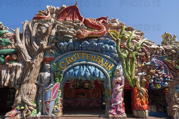 Entrance to the 'Grottenbahn' fairground ride decorated with figures