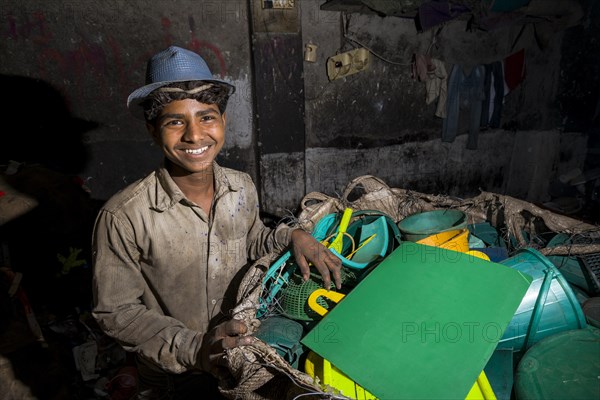 Worker sorting out plastic garbage for recycling