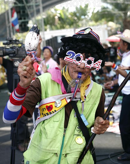 Old man with a whistle dancing amongst the protesters