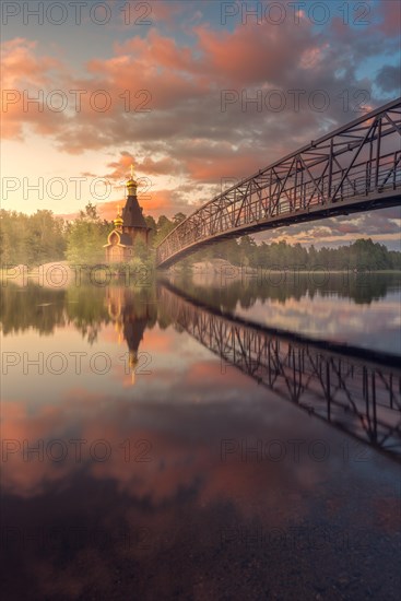 Bridge and Church of St. Andrew at Vuoksi River during sunset