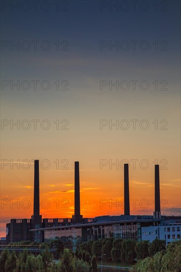 VW KonzernForum premises with the entrance to the Autostadt complex and the heating station of the Volkswagen plant with its four chimneys