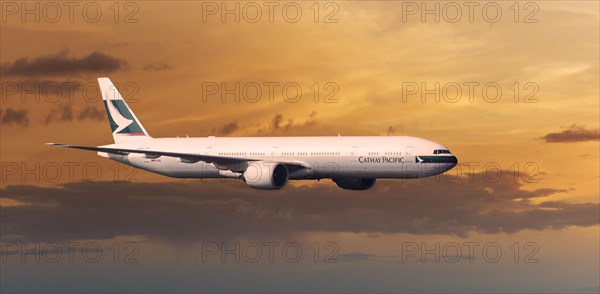 Cathay Pacific Boeing 777-367 ER in flight in the evening light