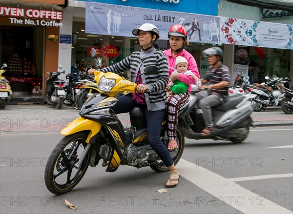 Two women with child on a motorcycle