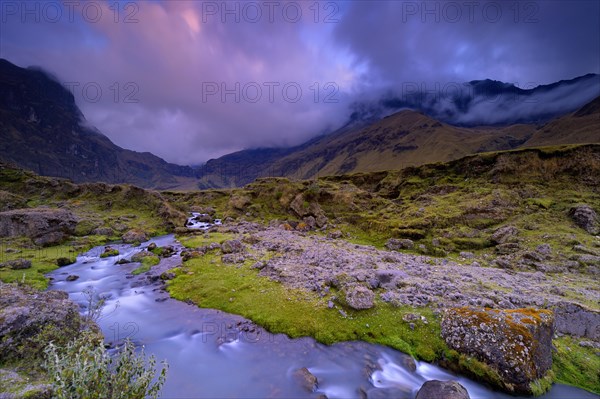 Mountain stream with the peaks of El Altar or Kapak Urku