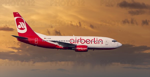 Air Berlin Boeing 737-73S in flight during a thunderstorm in the evening light
