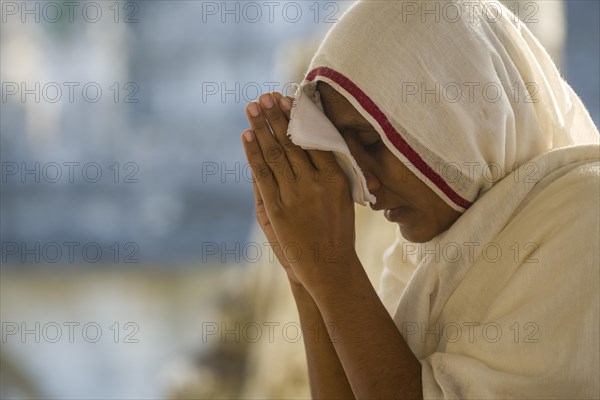 A Jain nun praying at a temple