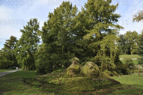 Stone statues overgrown with moss