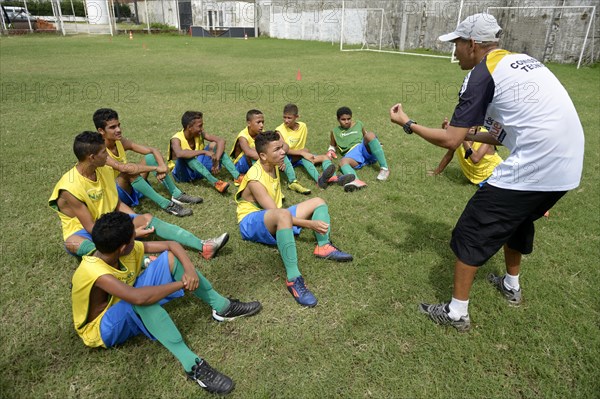 Coach giving young players technical instructions