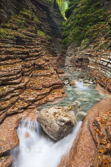 The Taugl river flowing through a red gorge