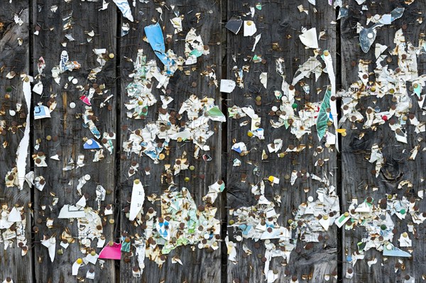 Wooden wall with poster scraps