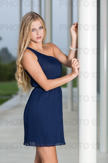 Woman wearing a short blue evening dress