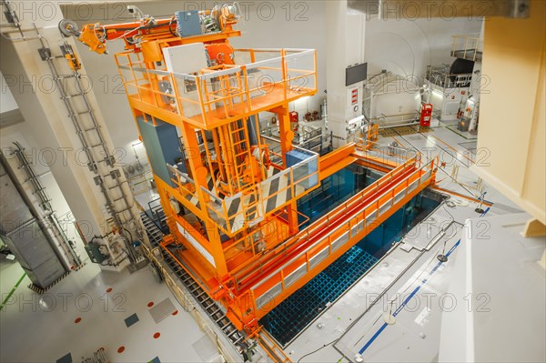 A crane above a cooling pond for spent fuel rods below the reactor dome at the Emsland nuclear power plant of the RWE Power AG