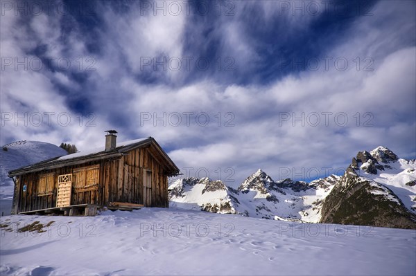 Alpine hut in a mountain landscape in winter