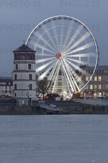 Rheinfront promenade with Schlossturm tower and an illuminated ferris wheel