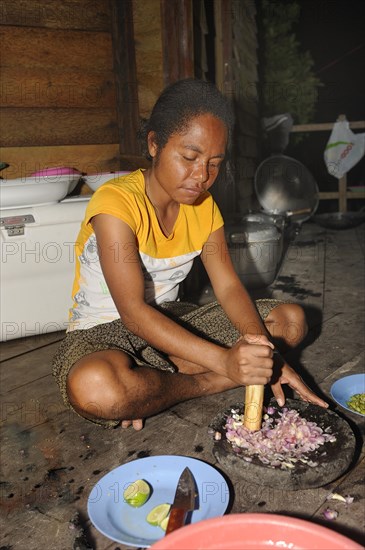 Papuan woman preparing food
