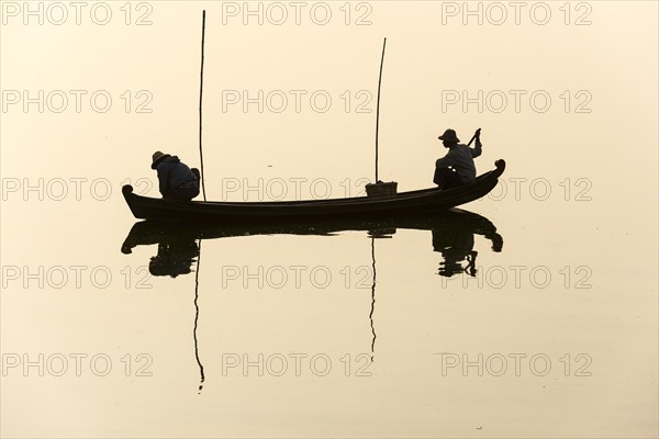 Fishermen in their boat in the morning light