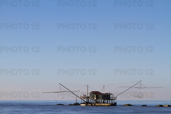 Fisherman's house with nets over the sea in Marina di Pisa