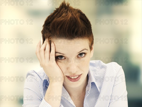 Young woman with her head propped up