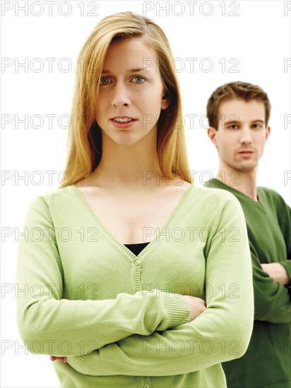 Young couple standing with their arms crossed