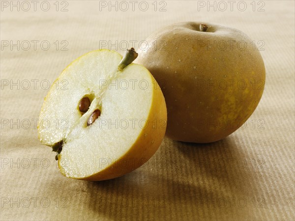 One whole and one cut Russet apple