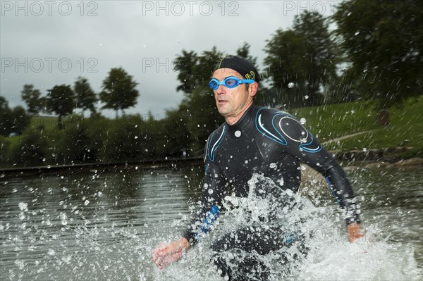 Triathlete running through water