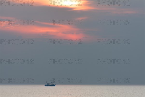 Shrimp boat at sunset