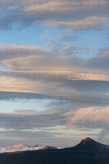 Mountain landscape in the evening light with a cloudy sky
