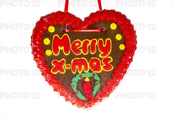 Gingerbread heart with the writing 'Merry X-mas'