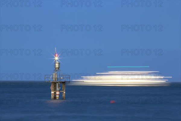 Evening mood with a with moving ship at the Hoernle Lighthouse