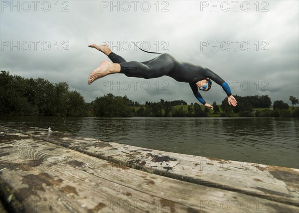 Triathlete diving into Aichstruter Reservoir