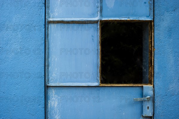 Blue-painted door with a window