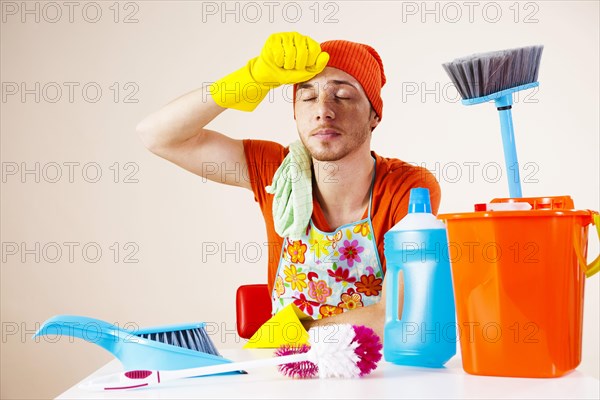 Young man looking exhausted after doing the the cleaning