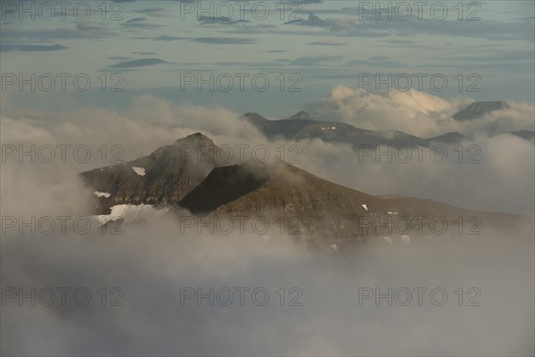 Mountain landscape in the evening light with looming clouds