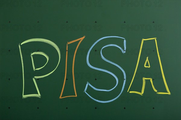 PISA' written with chalk on a blackboard