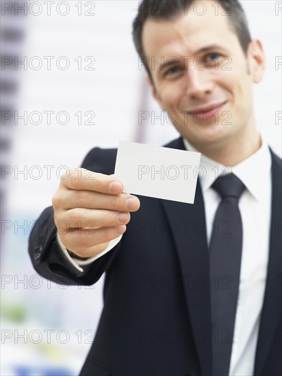 Businessman holding a blank business card