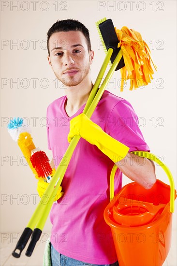 Man holding cleaning products in his hands