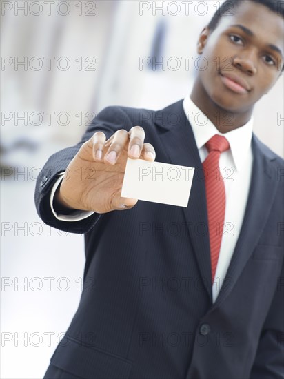 Businessman holding a blank business card