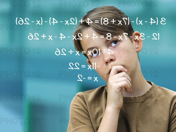 Schoolboy pensively in front of a math problem
