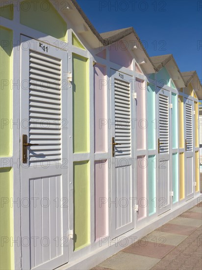 Pastel coloured beach cabins