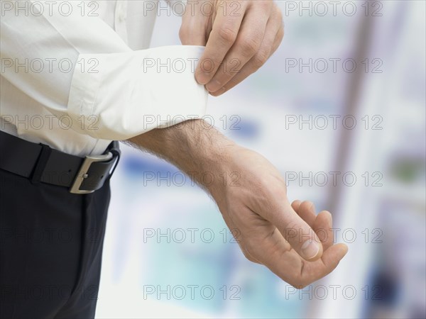 Businessman rolling up his sleeves