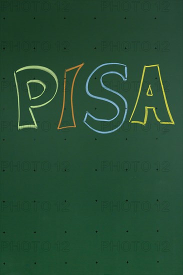 PISA' written with chalk on a blackboard