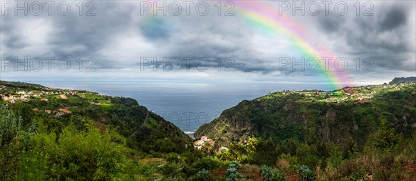 Rainbow above the cliffs at Arco de Sao Jorge