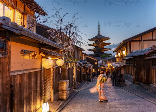 Woman in kimono in a lane