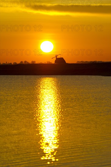 Sunrise with drawing well at Darscho-Lacke or Warmsee Lake