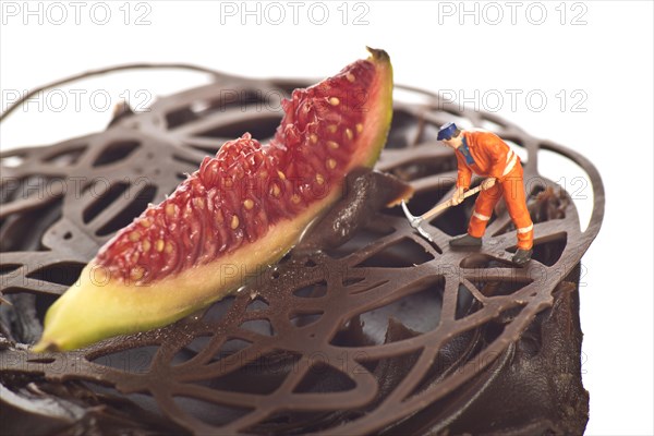 Miniature figure of a construction worker on a chocolate cupcake