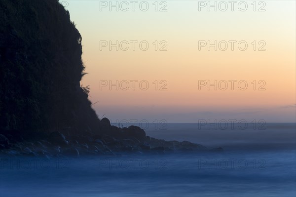 Cliffs and surf after sunset