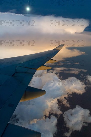 View from a Boeing 747-400 of a storm front at full moon
