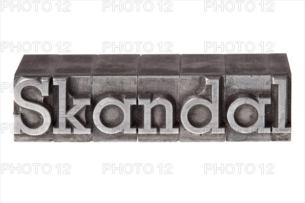 Old lead letters forming the word 'Skandal'